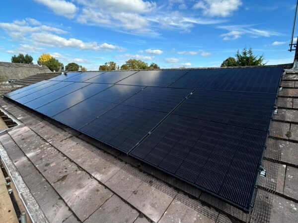 Solar panel installation on a side roof.